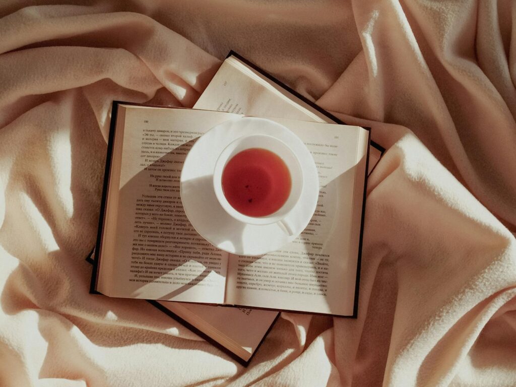 A cozy corner with self-care items like books, tea, and relaxation tools for grandparents. — emotional support grandpare…