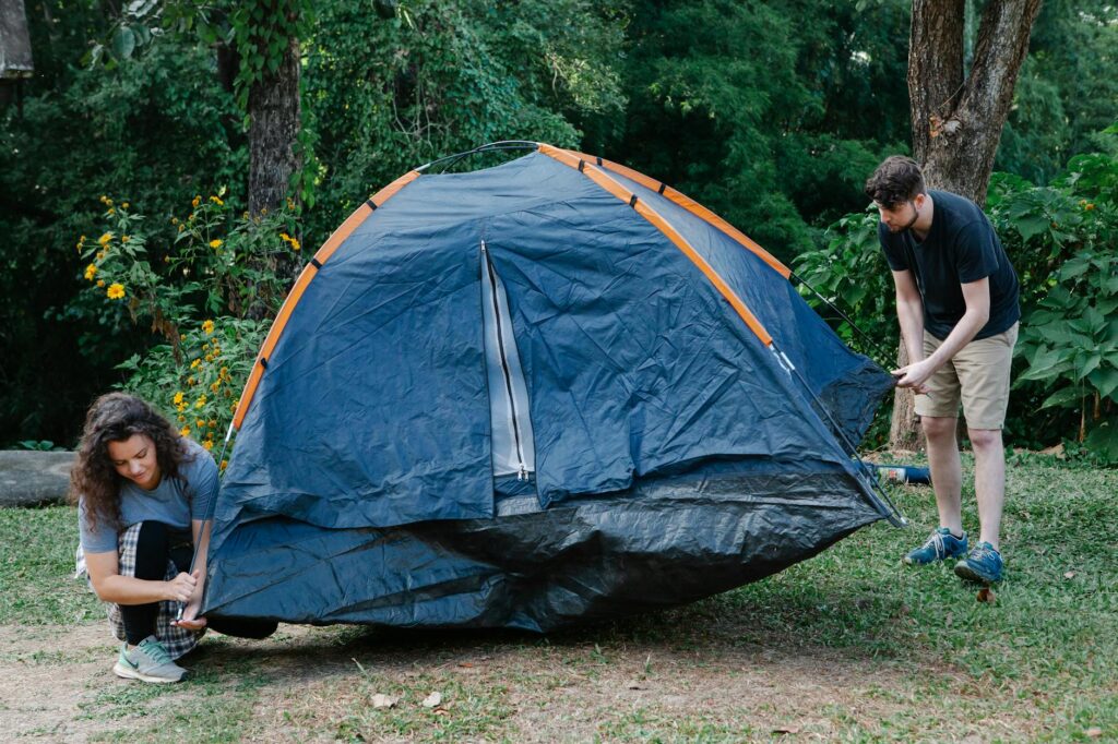A family camping together, setting up their tent in a beautiful outdoor setting. — family activities Utah