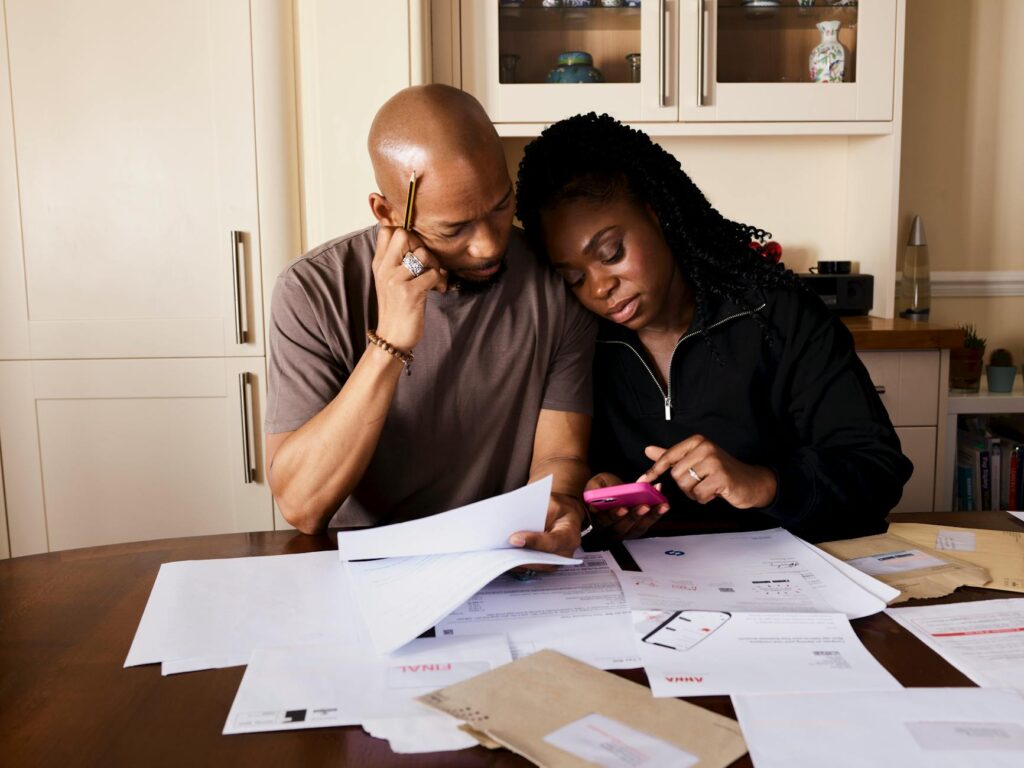 A family gathered around a table discussing budgeting plans. — financial planning grand families Utah