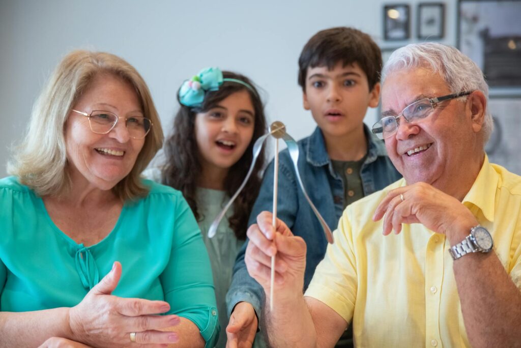 A friendly family photo featuring a grandparent with grandchildren engaging in a health-related activity. — health care …