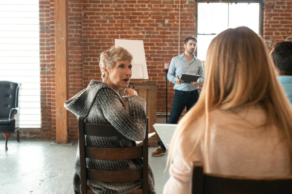A group of grandparents participating in a school meeting, discussing education policies. — grandparents educational equ…