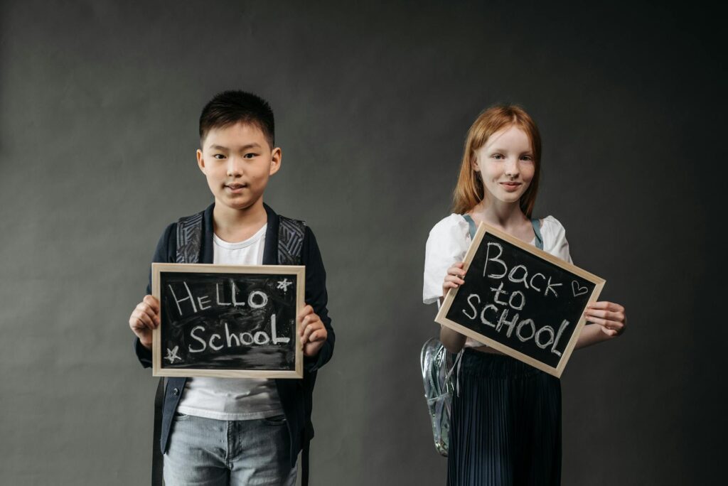 A happy grandchild holding school supplies ready for the first day of school. — enrolling grandchild in school Utah