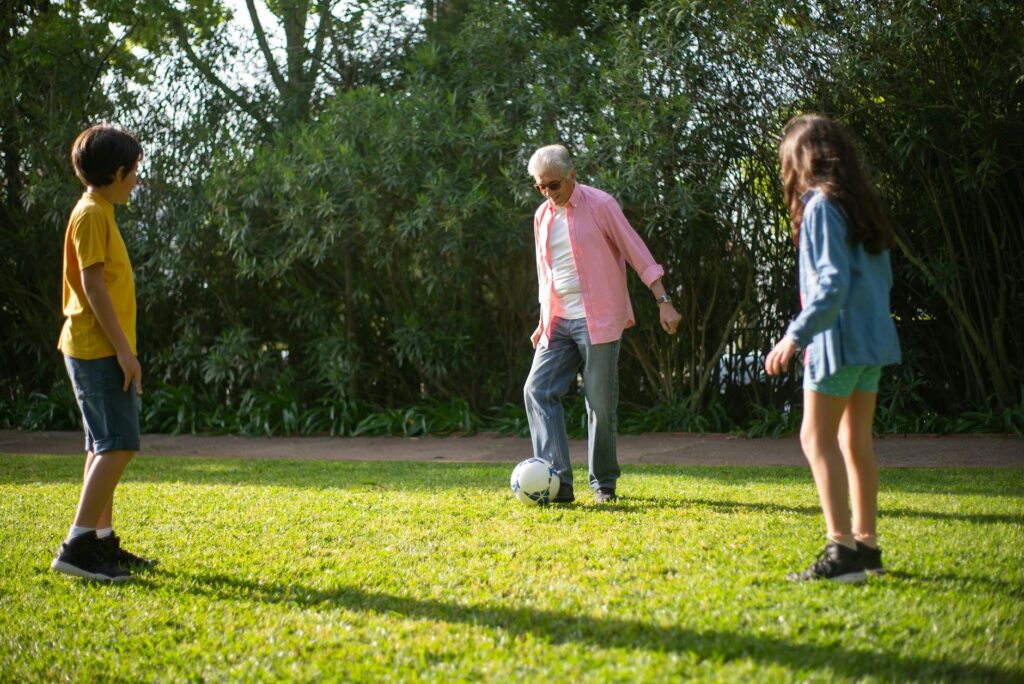 A happy grandfamily playing together outdoors, showcasing the bond between grandparents and grandchildren. — grandfamili…