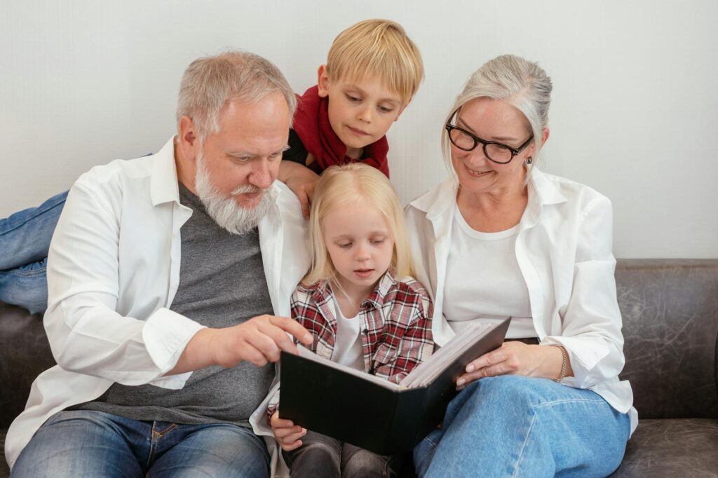 A happy grandparent reading to their grandchildren, symbolizing the importance of health and family. — health care grand…