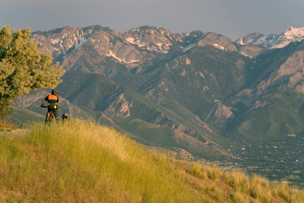 A scenic view of a Utah biking trail, with families riding together amidst nature. — family activities Utah