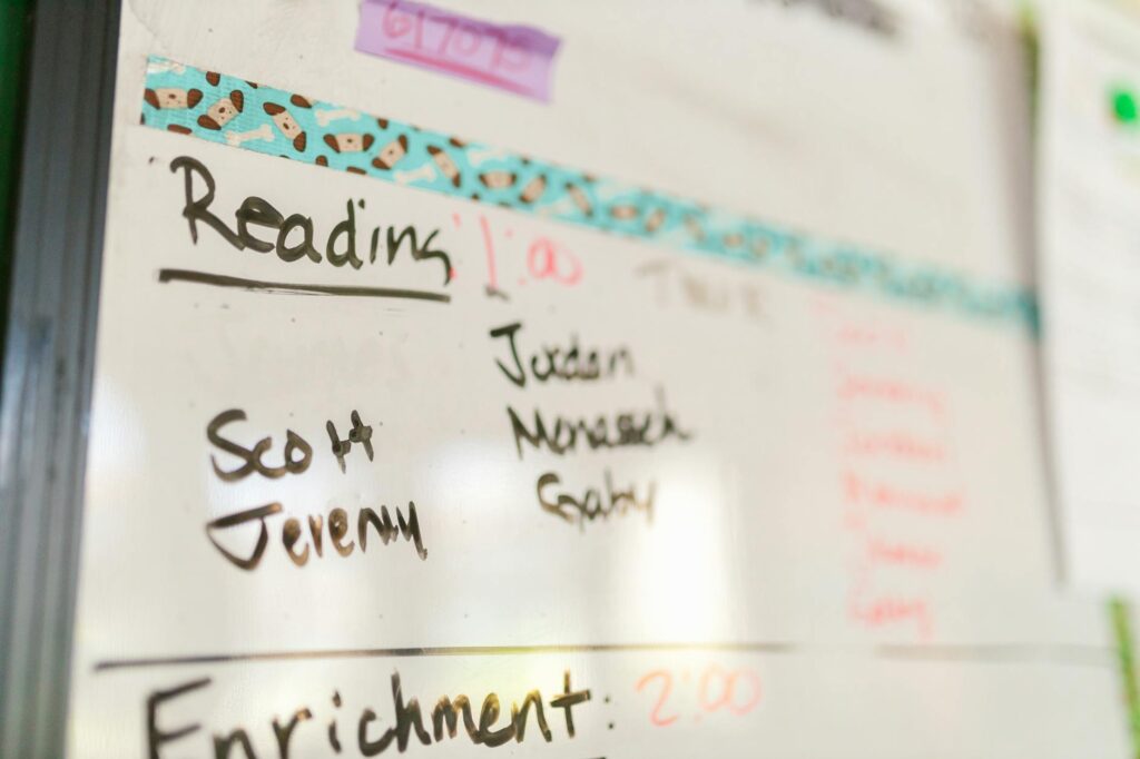 A schedule of daily learning activities displayed on a wall. — home learning environment grandfamilies Utah