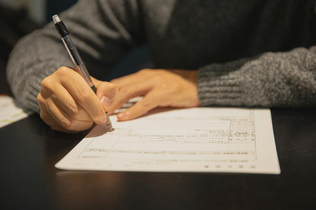 A school enrollment form with a pen and important documents on a table. — grandparent education rights Utah