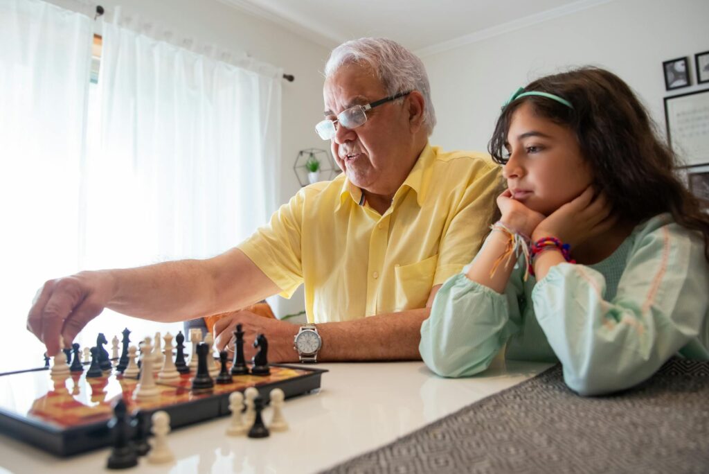 A supportive activity, like a puzzle or board game, between a grandparent and grandchild. — navigating emotions grandchi…