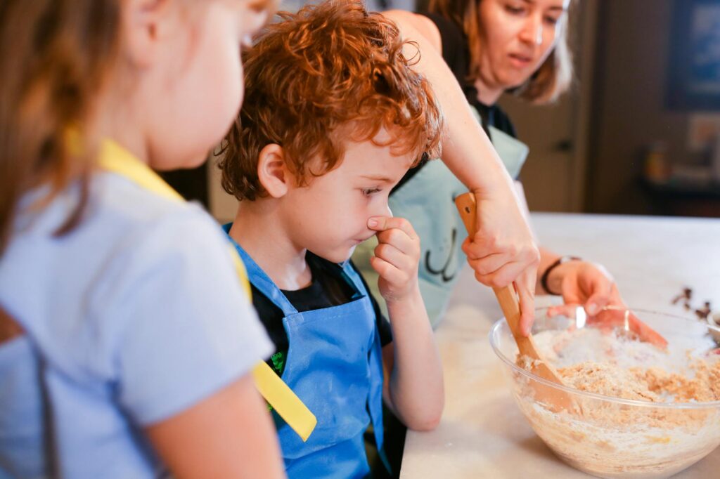 An artistic family cooking class, with kids and parents working together on a recipe. — family activities Utah