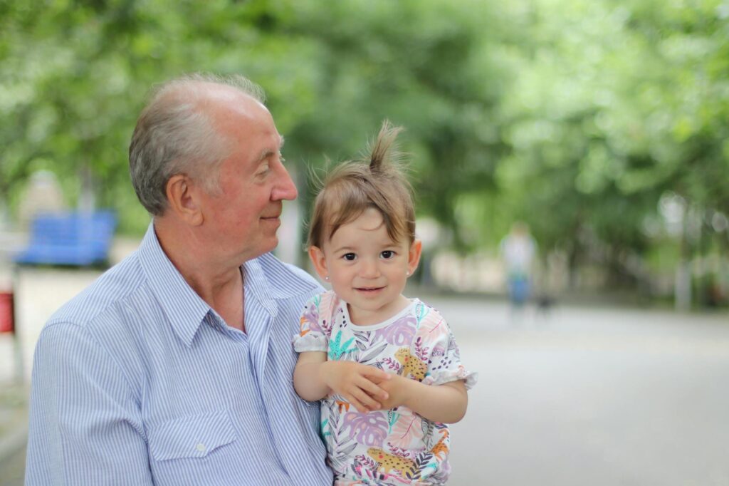 An image showing a happy grandparent with their grandchild in a park, symbolizing familial bonds and rights. — grandpare…