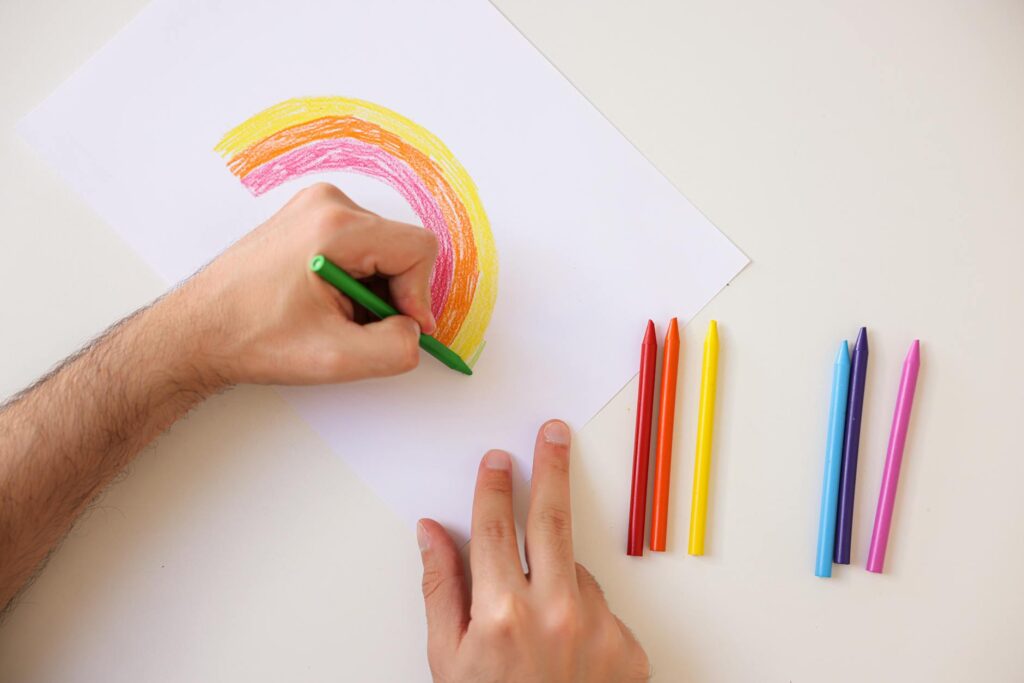 Art supplies like crayons and paper, representing creative expression for feelings in a safe space for grandchildren's fee…