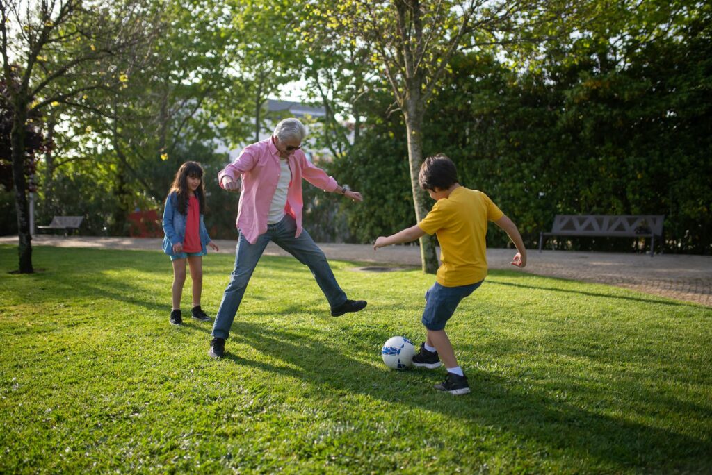 Grandparents and grandchildren participating in a fun outdoor activity, symbolizing positive engagement. — stability gra…
