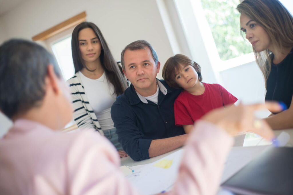 Image of a family discussing wills and trusts — legal documents grandparents Utah