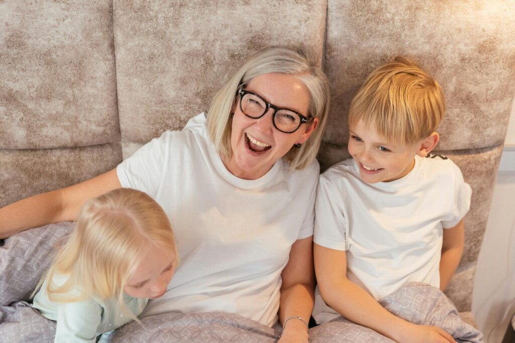 A cheerful grandparent with grandchildren discussing health insurance options. — health insurance grandparents Utah