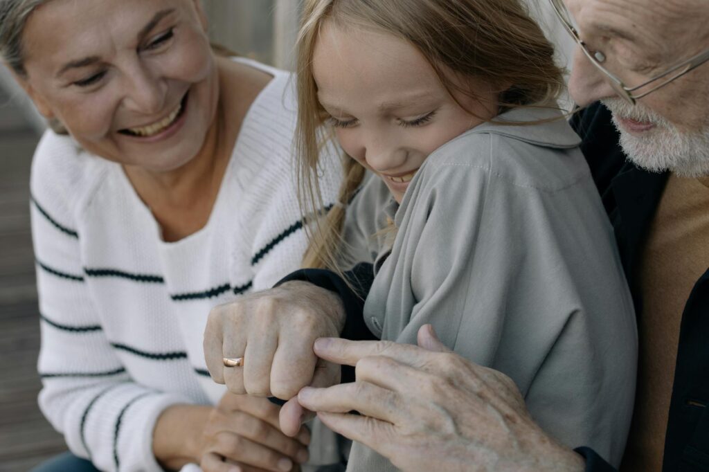 A close-up of grandparents sharing stories and experiences during a support group session. — grand families support grou…