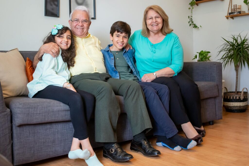 A family portrait of a grandparent with their grandchildren in a warm home setting. — Grand Families Utah