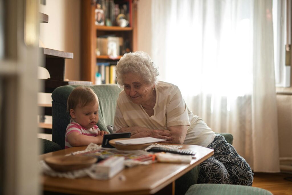A warm and inviting living room where a grandparent is reading with their grandchild, symbolizing support. — trauma impa…